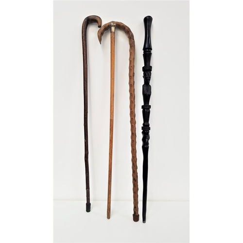 330 - BENIN CARVED EBONY WALKING STICK
with face mask detail, 92cm long; together with a silver topped wal... 