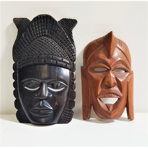 281 - TWO AFRICAN CARVED MASKS
one in ebony, 25.5cm high, the other in a hardwood, 20.5cm high (2)