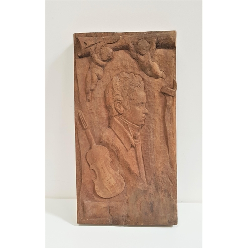 305 - LARGE MAHOGANY CARVED PANEL
depicting Robert Burns in profile, a violin and two cherubs, 72cm x 38cm