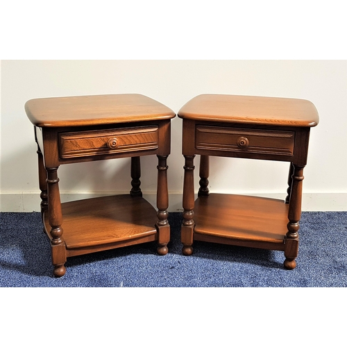 484 - PAIR OF ERCOL STYLE DARK ELM BEDSIDE TABLES
with moulded tops above a panelled frieze drawer with a ... 