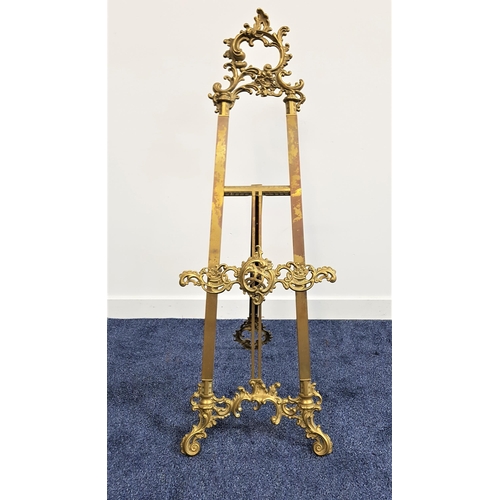 599 - GILT BRASS EASEL
decorated with scrolls, with an adjustable front stand, 119.5cm high