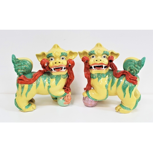 205 - PAIR OF CHINESE PORCELAIN DOGS OF FO
both decorated in yellow and green with red porcelain ribbons, ... 