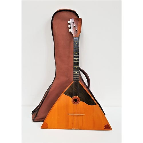 380 - RUSSIAN BALALAIKA
with a an arched back and flat triangular front, with three strings, in a soft she... 