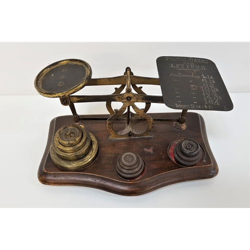 276 - 19th CENTURY SET OF POSTAL SCALES
raised on a shaped base with various weights, the scales with impr... 