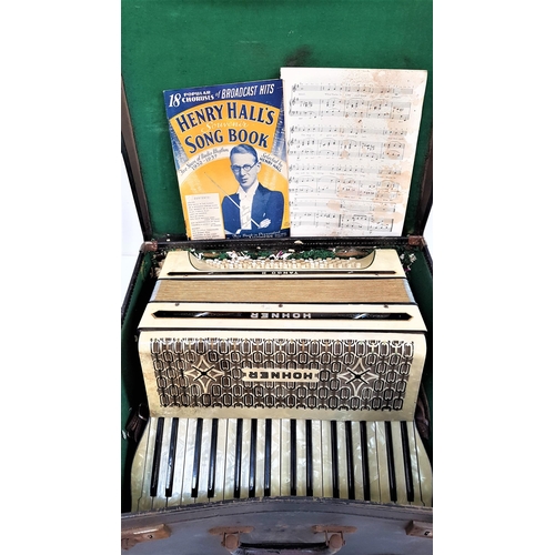 372 - HOHNER TANGO II ACCORDIAN
in mottled white with leather shoulder straps, cased