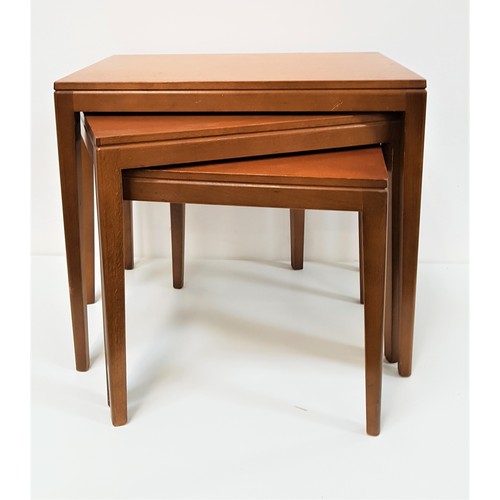 602 - NEST OF TEAK TABLES
with rectangular tops, standing on tapering supports, 46cm high