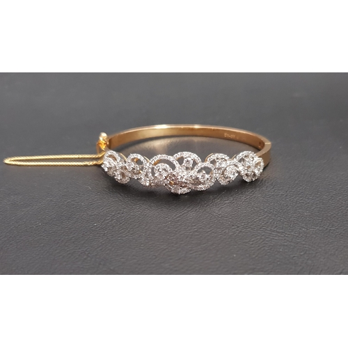 63 - IMPRESSIVE DIAMOND SET TWENTY-ONE CARAT GOLD BANGLE
the multi diamonds in pierced and scrolling sett... 