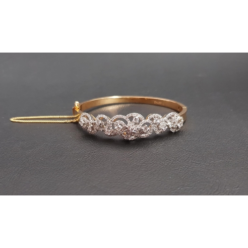 63 - IMPRESSIVE DIAMOND SET TWENTY-ONE CARAT GOLD BANGLE
the multi diamonds in pierced and scrolling sett... 