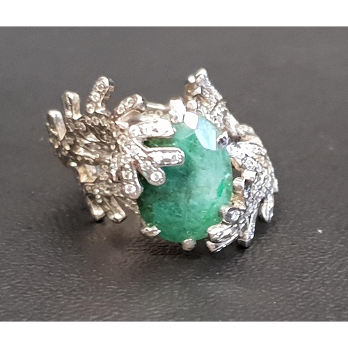 92 - UNUSUAL EMERALD AND DIAMOND DRESS RING
the central oval cut emerald within a diamond set fern effect... 