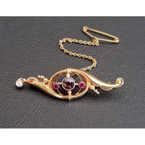 66 - GARNET AND RUBY SET SCROLL DESIGN BROOCH
in nine carat gold, the central round cut garnet flanked by... 