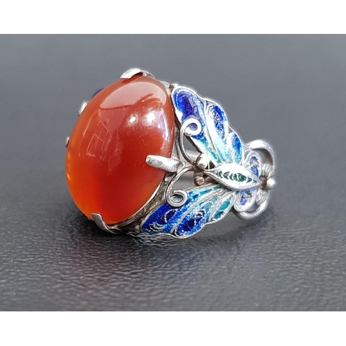 72 - UNUSUAL AGATE AND ENAMEL DECORATED RING
the central oval cabochon agate flanked by enamel decorated ... 