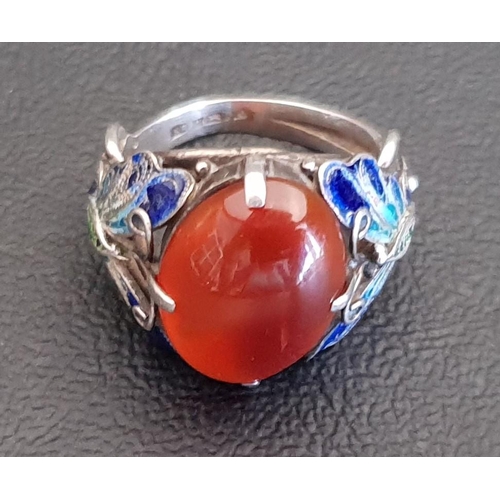 72 - UNUSUAL AGATE AND ENAMEL DECORATED RING
the central oval cabochon agate flanked by enamel decorated ... 