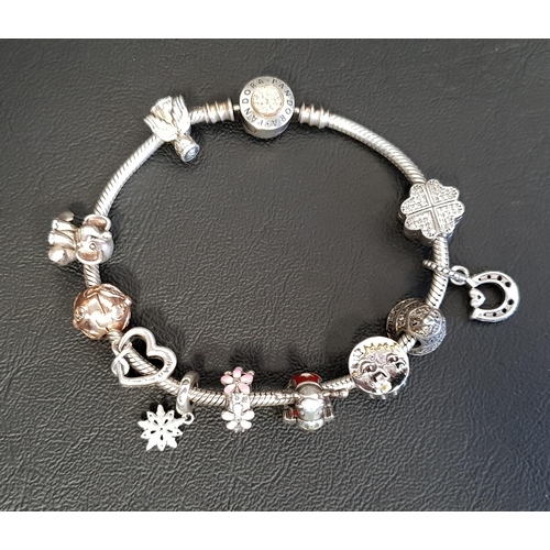 84 - PANDORA MOMENTS SILVER CHARM BRACELET
with logo sparkle clasp, four Pandora charms and two clips; to... 