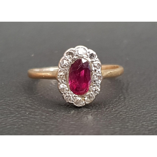 70 - RUBY AND DIAMOND CLUSTER RING
the central oval cut ruby in twelve diamond surround, on unmarked gold... 