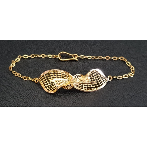 67 - HIGH CARAT GOLD BRACELET
with central pierced bow, with Arabic mark, testing as high carat, approxim... 