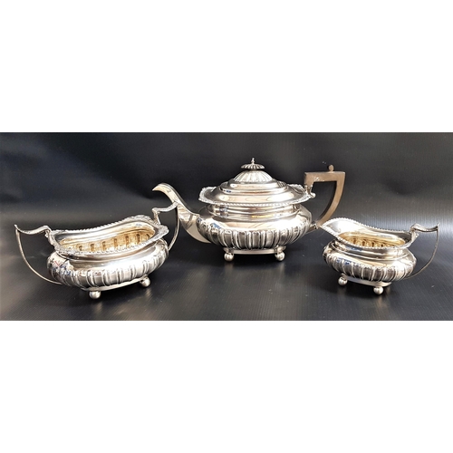 193 - GEORGE V SILVER TEA SET
comprising a tea pot, twin handled sugar bowl and milk jug, all on ball feet... 
