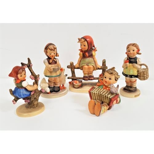 260 - FIVE GOEBEL FIGURINES
including a girl seated on a fence, 13cm high, girl feeding geese, 11.5cm high... 