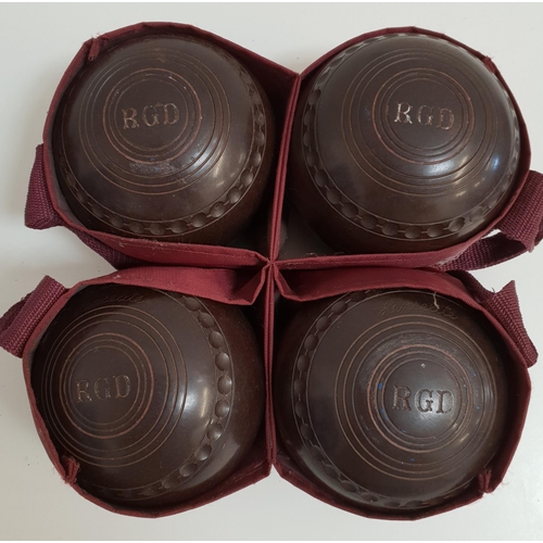 393 - SET OF FOUR LAWN BOWLS
by Henselite, size 4 and monogrammed RGD, with a carry bag