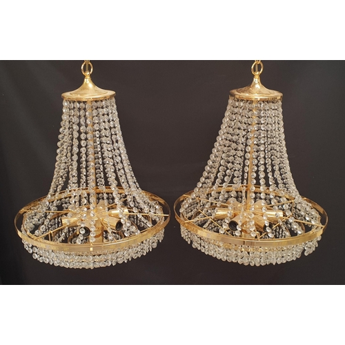 595 - PAIR OF CHANDELIERS
with cut glass bead decoration around a brass frame with a lower circular brass ... 