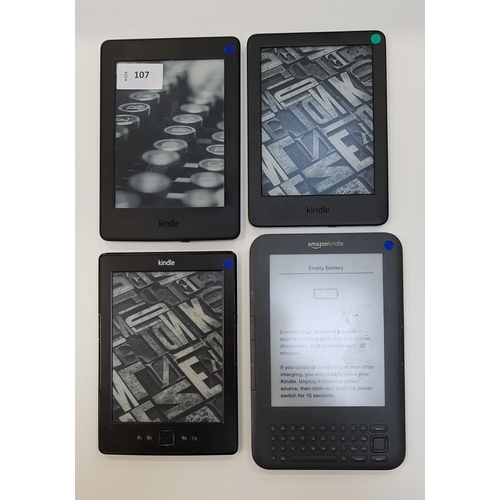 107 - FOUR AMAZON KINDLE E-READERS
comprising a Paperwhite 3 7th generation, serial number G090 G105 8013 ... 