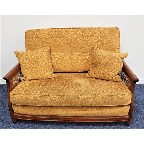 544 - ERCOL BERGERE SOFA
in elm with caned side panels, back, seat and scatter cushions in yellow damask, ... 