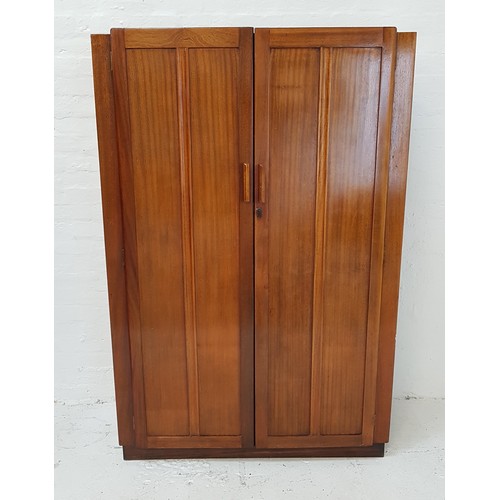 524 - 1930s TEAK WARDROBE
with a pair of panelled doors opening to reveal an internal mirror and hanging s... 