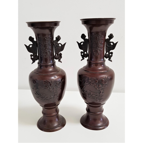 297 - PAIR OF CHINESE HU SPELTER VASES
with Archaic bird decoration, raised on a circular base, 32cm high ... 