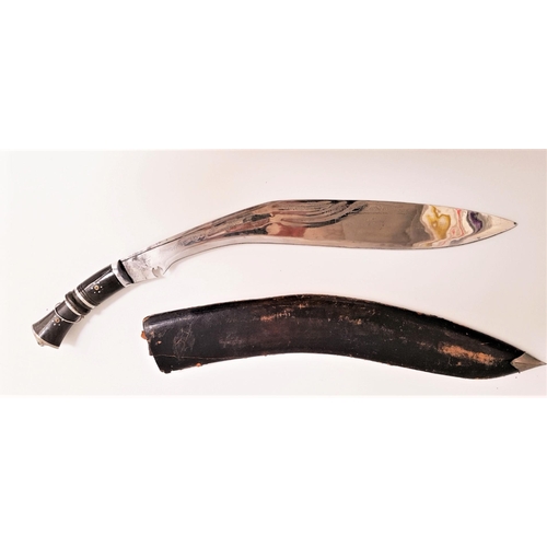 311 - LARGE KUKRI KNIFE
with a curved 60cm etched blade and ebony handle with a lion mask, contained in a ... 