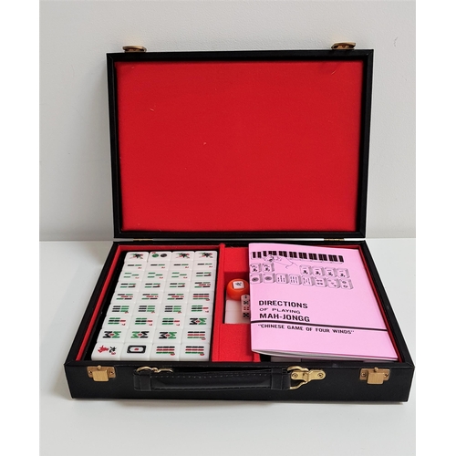 313 - CASED MAH-JONGG SET
with hard plastic tiles and dice, with instruction booklet, in an atache style c... 