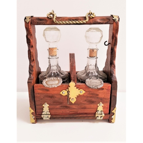 324 - 20th CENTURY PINE AND BRASS MOUNTED TANTALUS
with two decanters and stoppers with a gin and whisky l... 