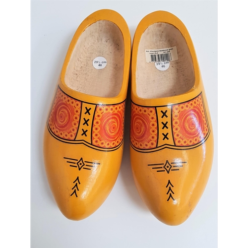 418 - PAIR OF DUTCH CARVED CLOGS
of one piece construction and painted yellow with a geometric design, siz... 