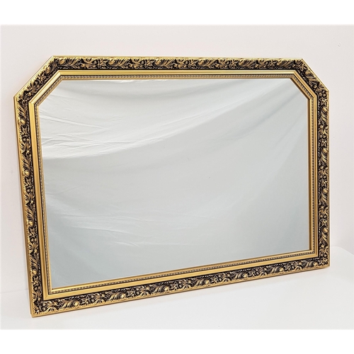 533 - LARGE SHAPED GILTWOOD MIRROR
in a decorative frame with a plain plate, 102.5cm wide