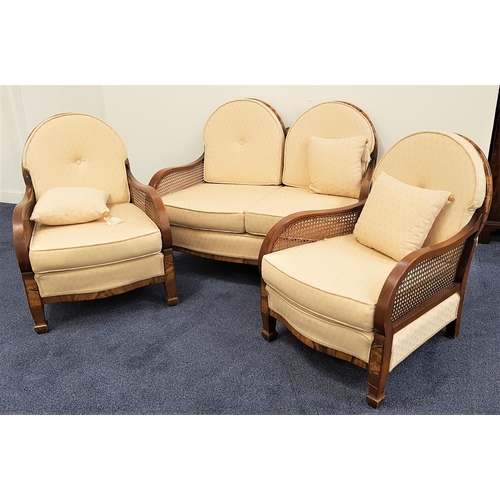 566 - WALNUT AND FIGURED WALNUT THREE PIECE SUITE
comprising a two seat sofa with a double arched and cane... 