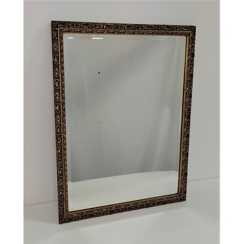 605 - RECTANGULAR WALL MIRROR
with a bevelled plate and a carved and pierced giltwood frame, 67cm x 52cm