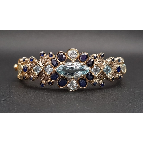 72 - BLUE TOPAZ, SAPPHIRE AND DIAMOND SET BANGLE
in silver gilt with pierced detail to the reverse of the... 