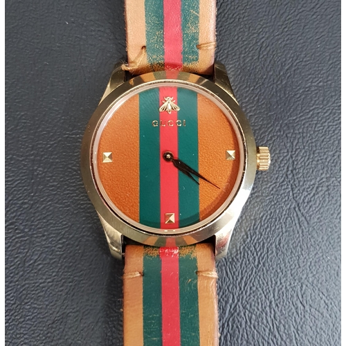 23 - GENTLEMAN'S GUCCI G-TIMELESS WRISTWATCH
the dial and strap with green and red stripe detail, the bac... 