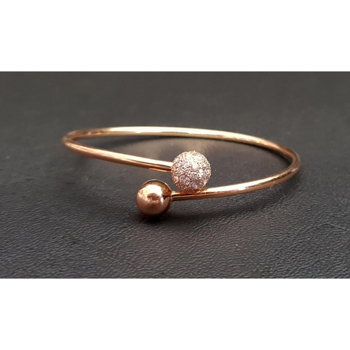 56 - TIFFANY & CO DIAMOND BALL BYPASS BRACELET
in eighteen carat rose gold, the diamonds totalling 1.14ct...