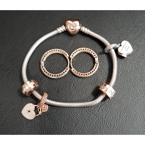 106 - PANDORA MOMENTS SILVER CHARM BRACELET
with Pandora Rose heart clasp, two charms and two clips; toget... 