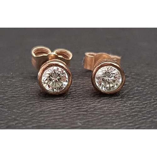 61 - PAIR OF BEZEL SET DIAMOND STUD EARRINGS
the diamonds totalling approximately 0.5cts, in nine carat g... 