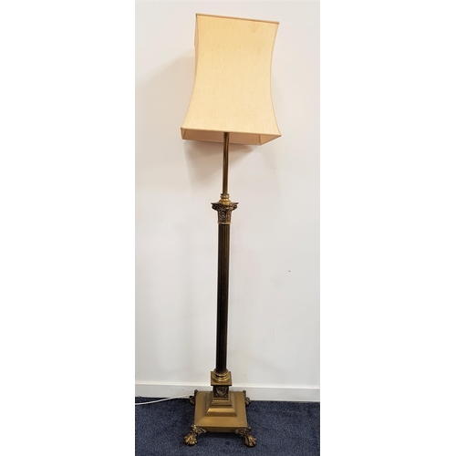 567 - EARLY 20th CENTURY BRASS STANDARD LAMP
raised on a square stepped base with lion paw feet, with a re... 