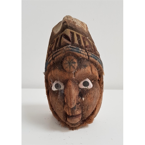 329 - 20th CENTURY CARVED COCONUT
decorated with a face with painted shell eyes below the word Trinidad, 1... 