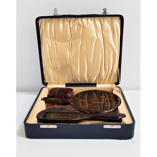 333 - FAUX TORTOISESHELL DRESSING TABLE SET
in a fitted box, comprising a hair brush, hand mirror and soap... 