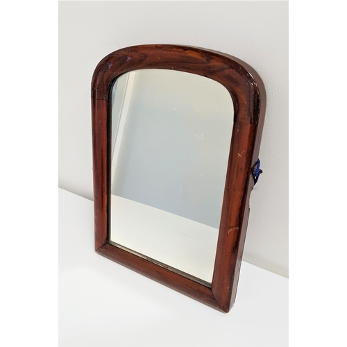 516 - LATE VICTORIAN STAINED PINE MIRROR
with an arched frame and plate, previously from a dressing chest,... 