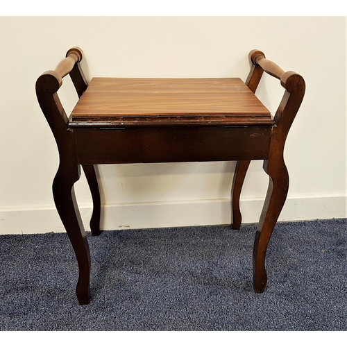 517 - EDWARDIAN MAHOGANY PIANO STOOL
with a lift up seat flanked by turned handles, standing on shaped sup... 