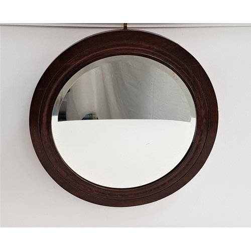 574 - 1930s CIRCULAR OAK FRAME WALL MIRROR
with a bevelled plate, 54cm diameter