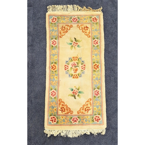 582 - CHINESE RECTANGULAR WASH RUG
with a cream ground and pale blue floral border, fringed, 158cm x 77cm ... 