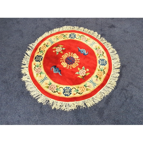 583 - CHINESE CIRCULAR WASH RUG
with a red ground and cream floral border, fringed, 126cm diameter excludi... 