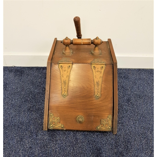 588 - EDWARDIAN OAK COAL SCUTTLE
with a wooden carry handle and decorative brass hinges to the slanted lif... 