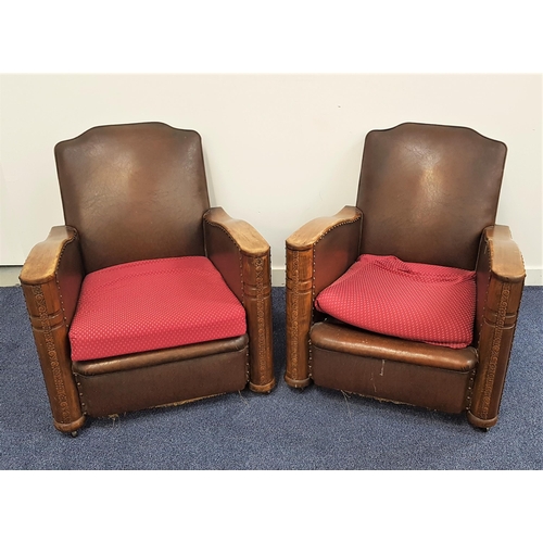 590 - PAIR OF 1920s CLUB ARMCHAIRS
with oak shaped arms and a shaped padded back, sides and loose seat cus... 