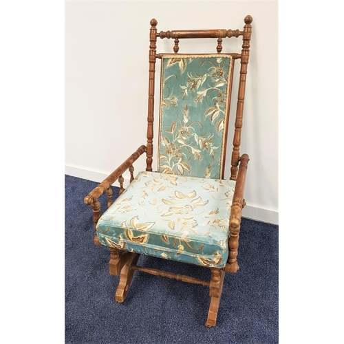 592 - EDWARDIAN MAHOGANY ROCKING CHAIR
with a central padded back and loose seat cushion